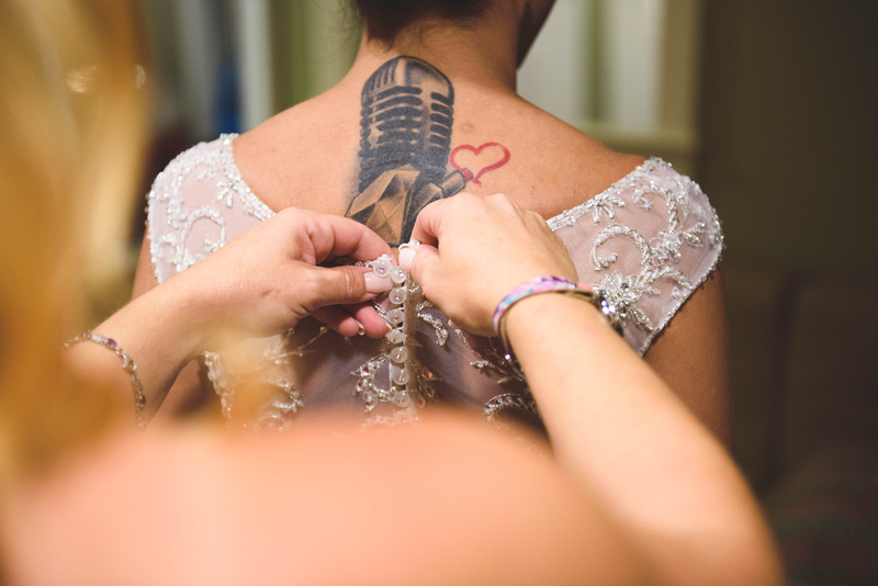 Amber getting her wedding dress buttoned up.