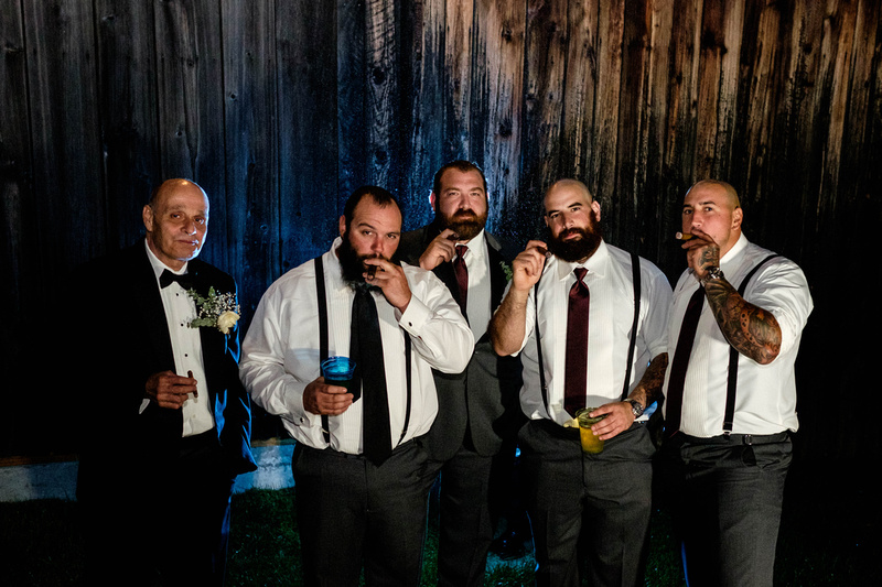 Groomsmen smoking cigars.